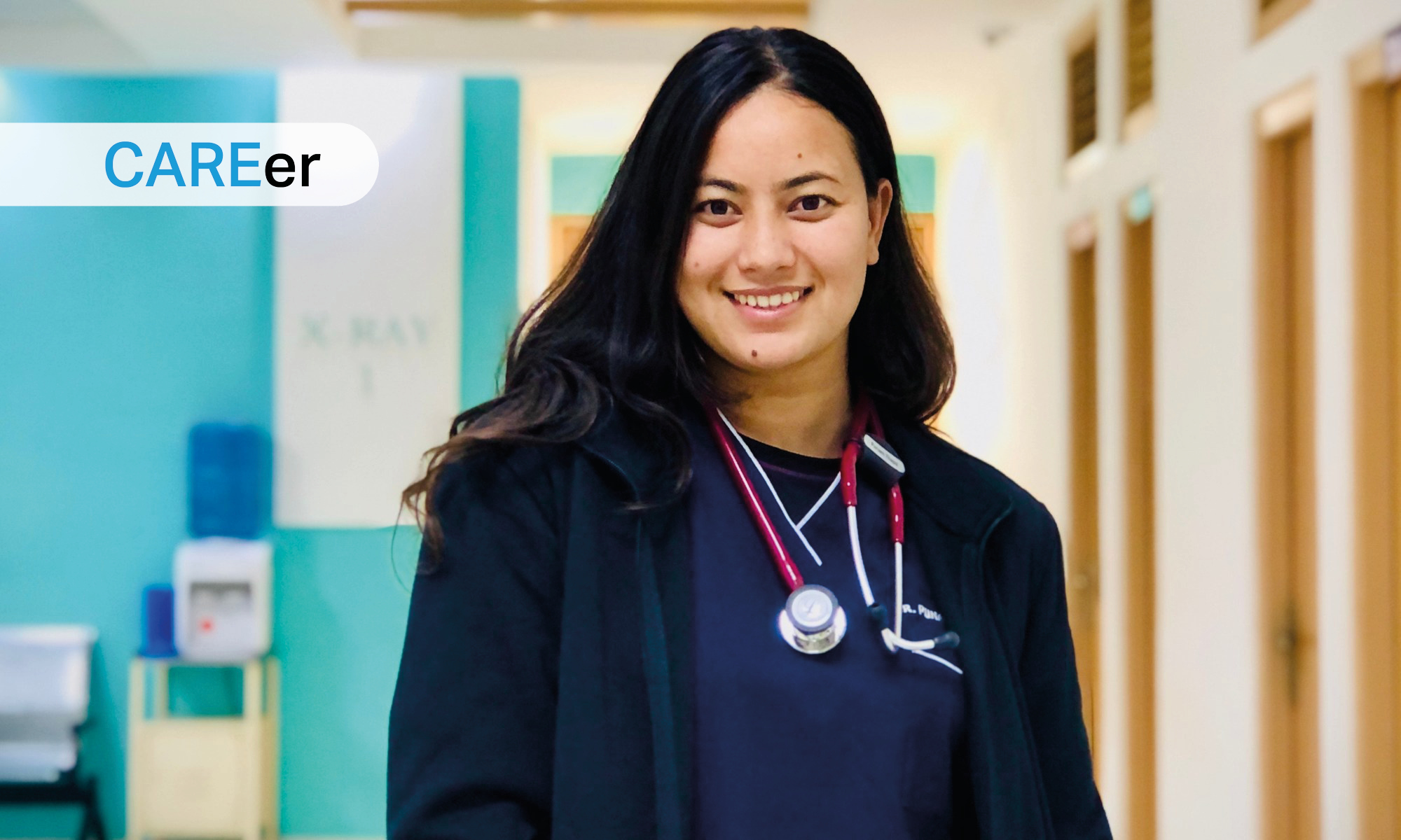 Smiling healthcare professional in a hospital hallway